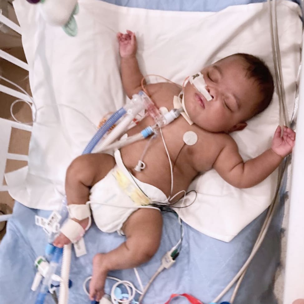 Jayden in crib with tubes and wires.